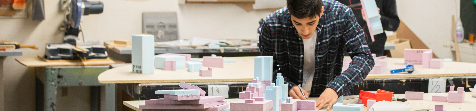 Two men stand in a warehouse.