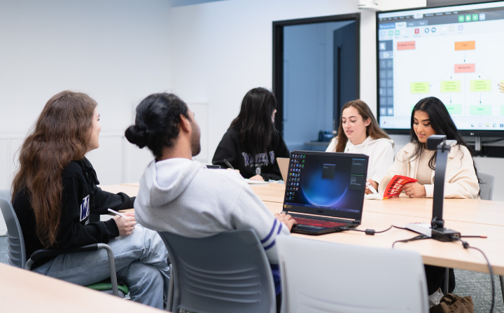Several students sit around a table.