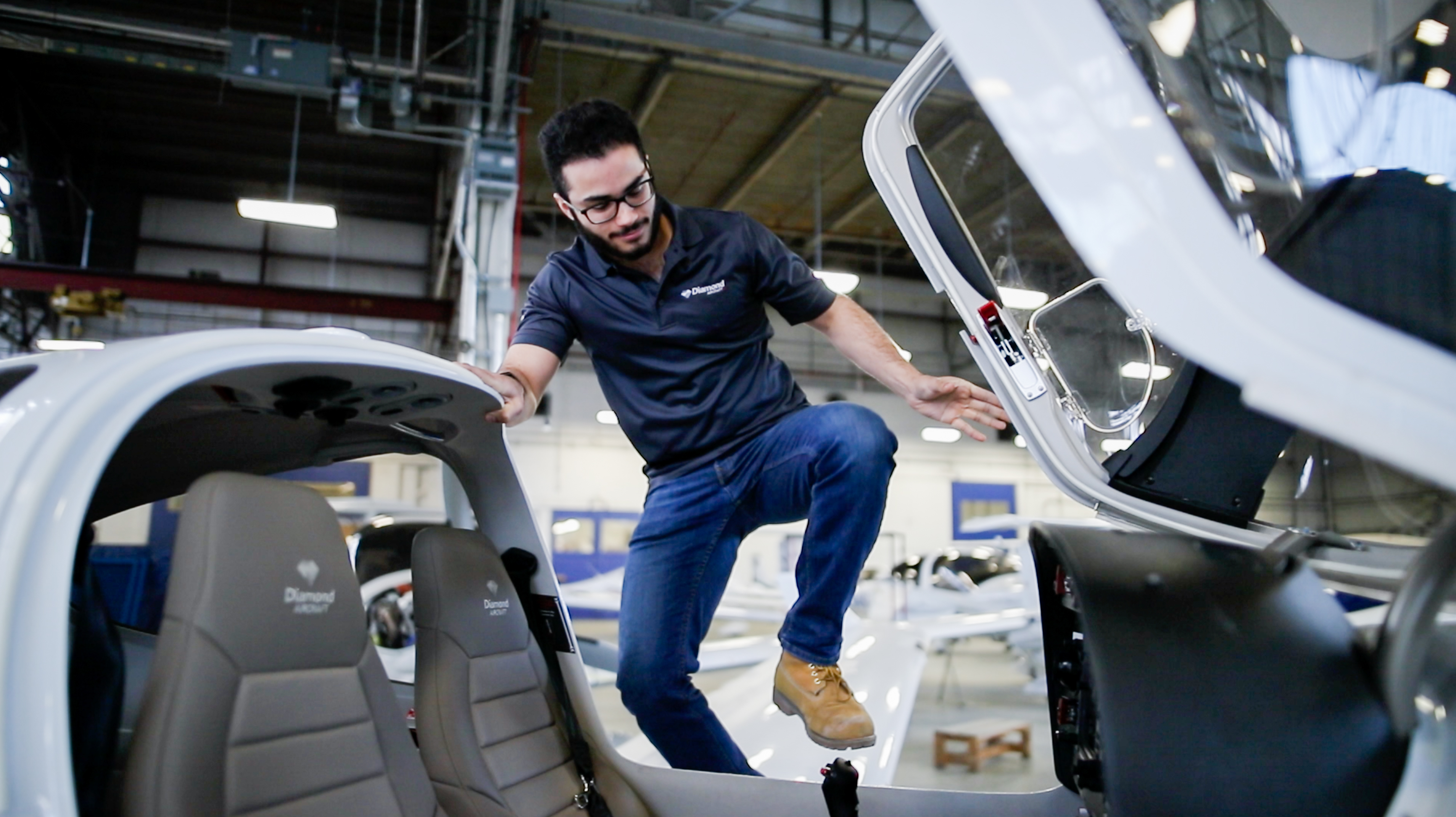 An image of a young man gettign into a plane.